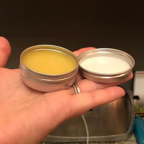 Silver round tin by Ymkf Sqqr, versatile for candles, salves, and teas.