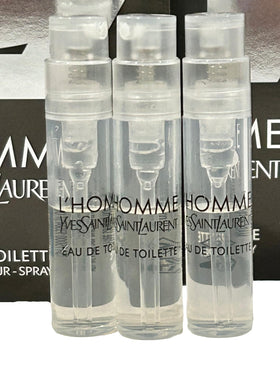 Three partially filled Yves Saint Laurent EDT vials for testing aroma