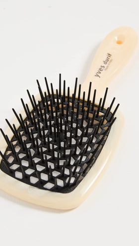 Close-up of Yves Durif brush showing carbon fiber core and ergonomic grip