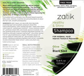 Zatik bottle close-up showing rich lather on wet hair.
