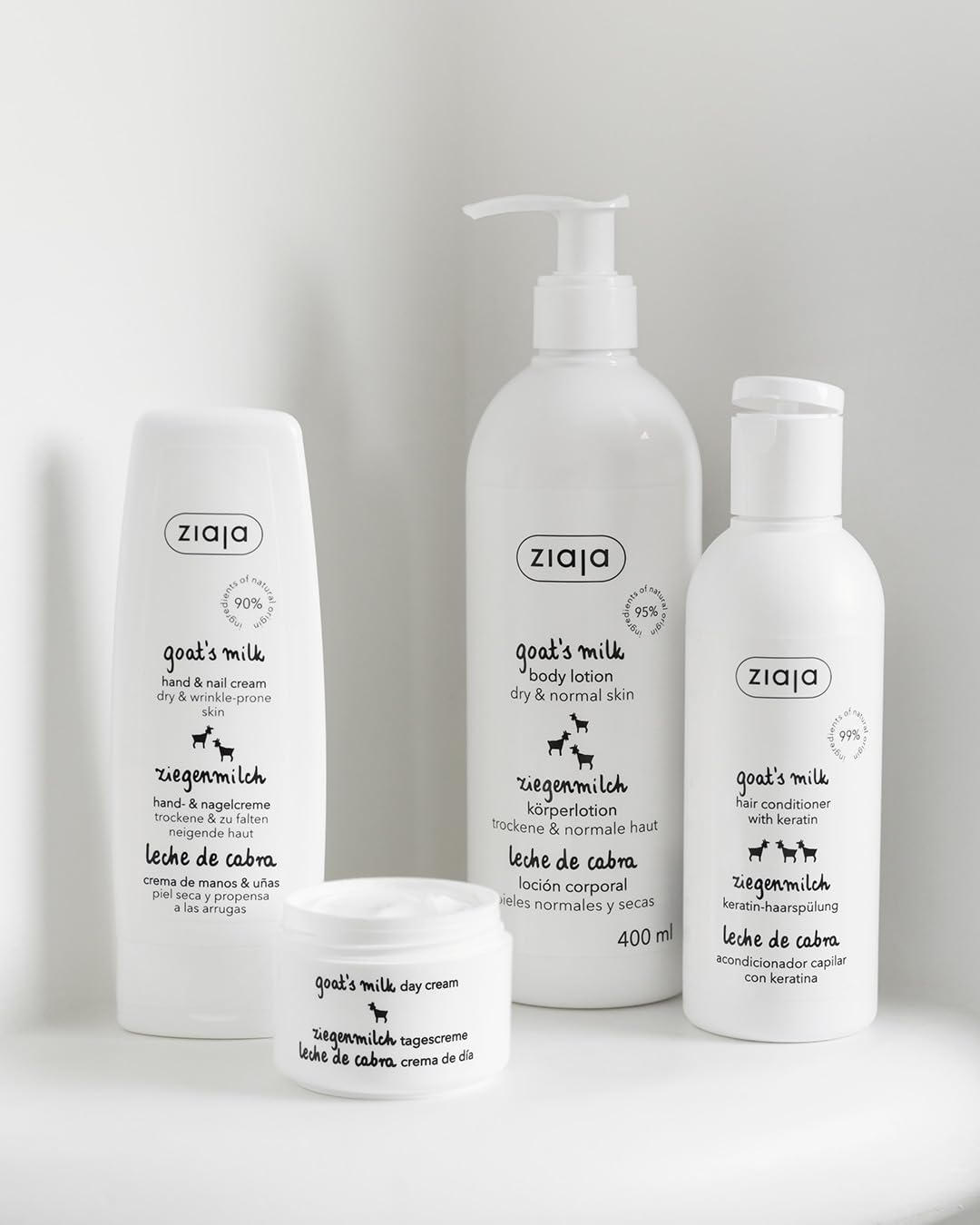 Hands applying Ziaja Goat's Milk Body Lotion to dry skin for daily hydration