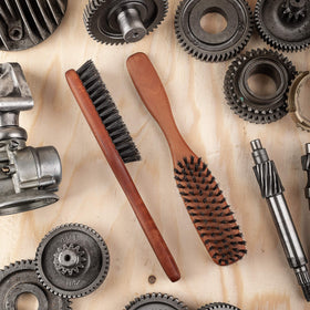 ZilberHaar brush paired with balms and oils for even product distribution.